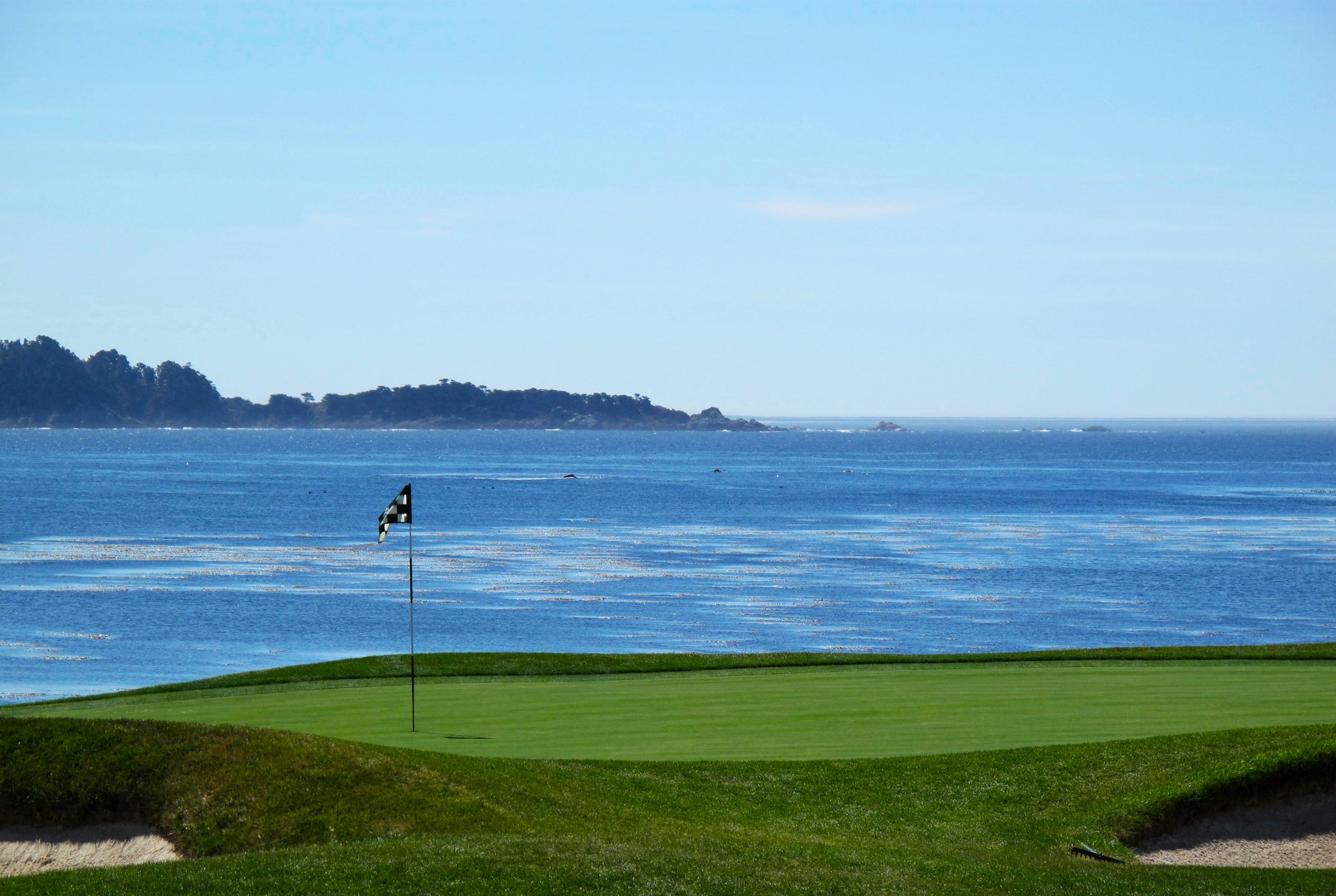 A golf green beside the Pacific Ocean at Pebble Beach