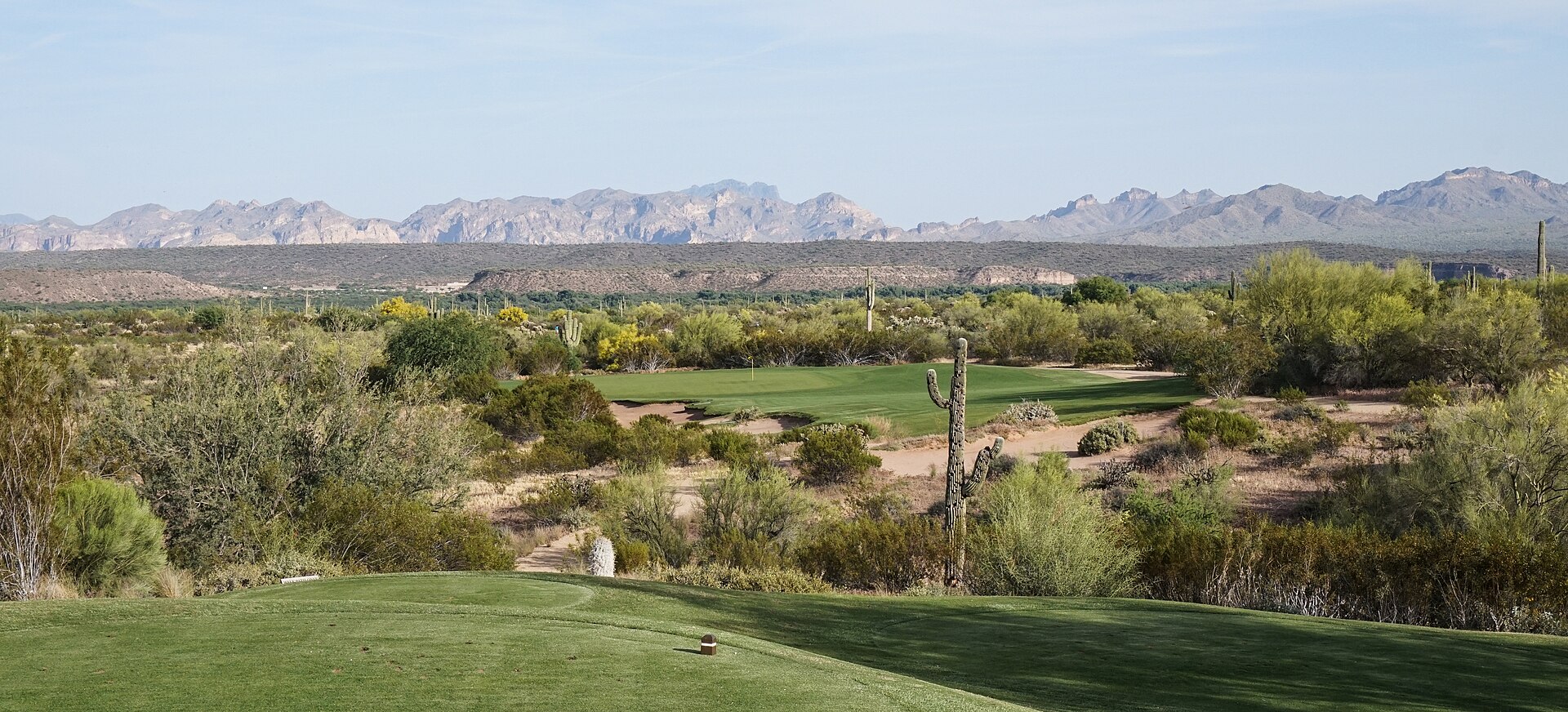 A Scottsdale golf course with desert mountains beyond the fairway